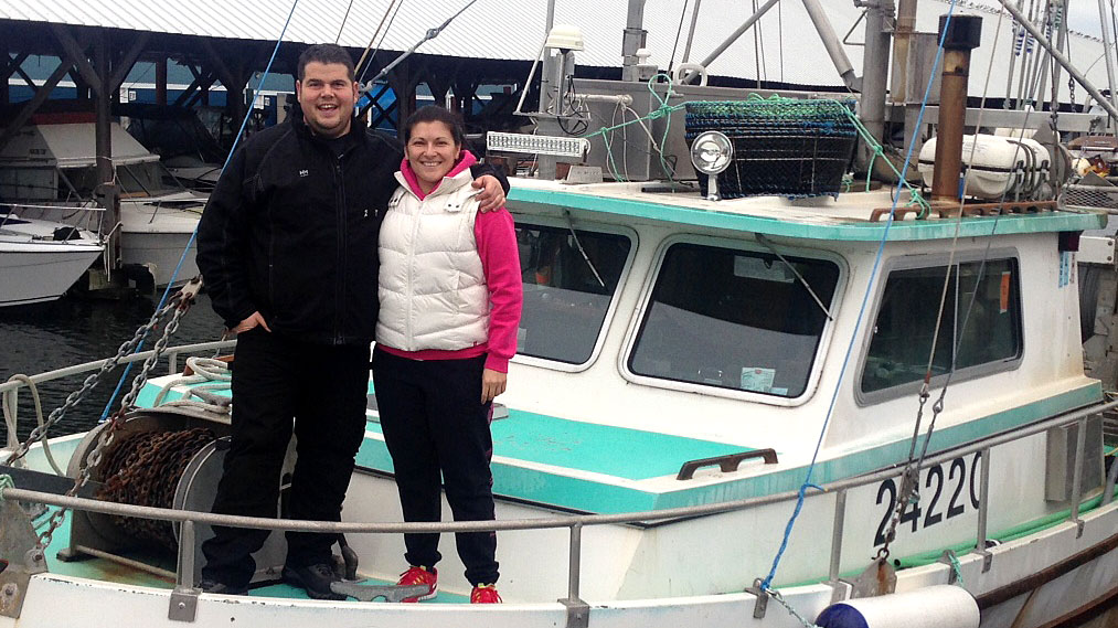 Angy & Zeke Pellegrin standing on the deck of one of their fishing boats.