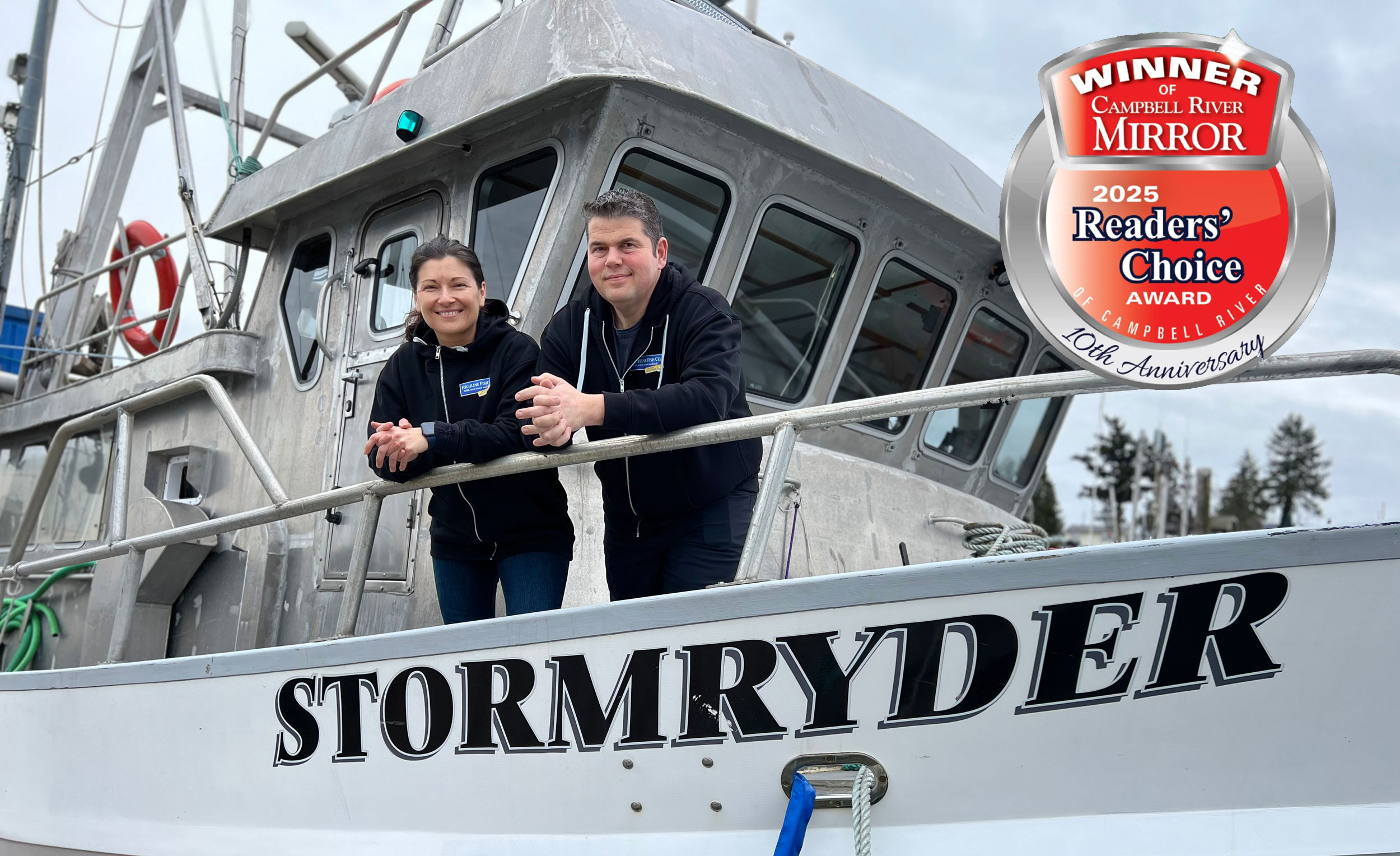 Zeke and Angy standing on the deck of the Stormryder, their fishing vessel.