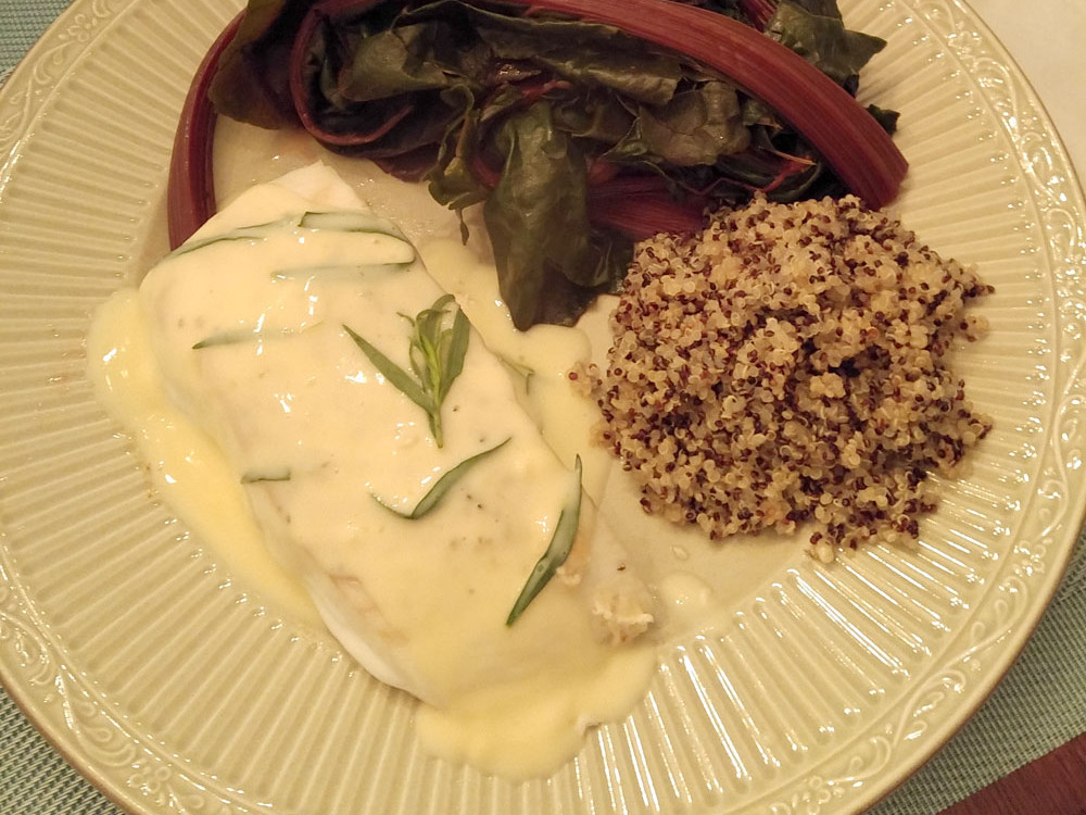 White plate with Bernaise Halibut, rhubarb, rice and a glass of white whine.